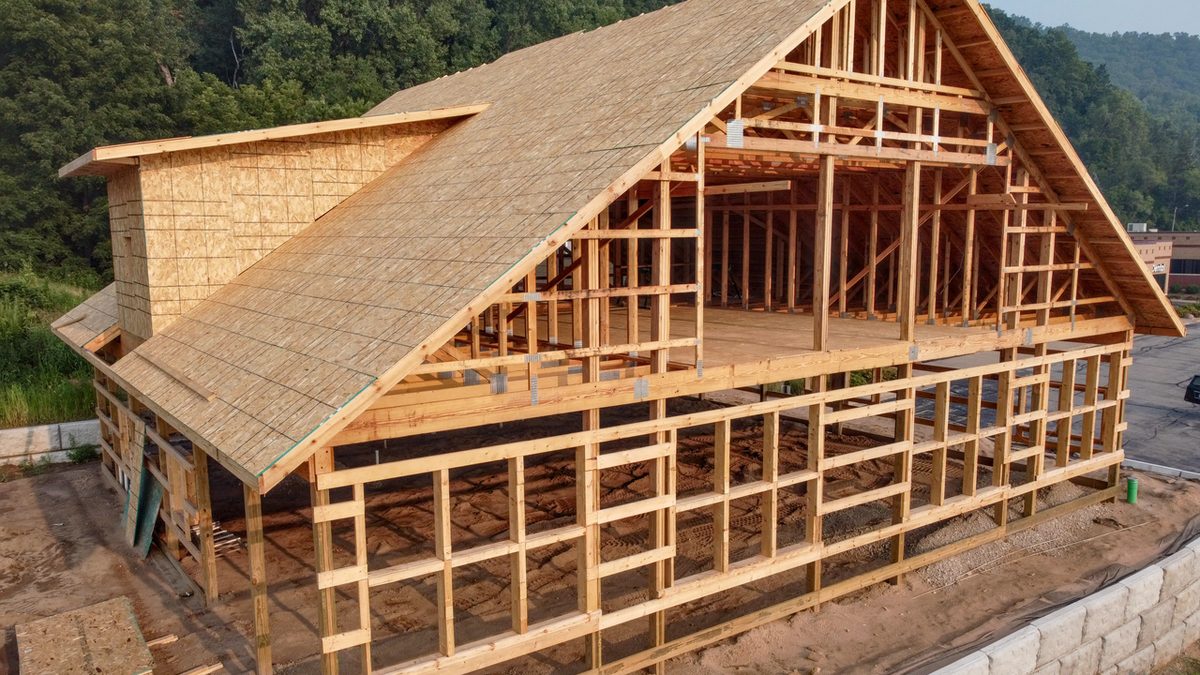 Aerial of multi-story post-frame building in framing with loft platform.