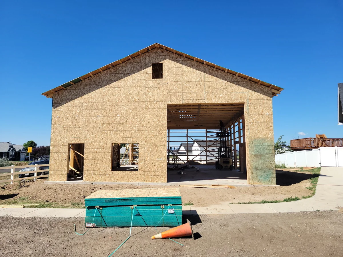 Gable wall with OSB sheathing, a large opening and smaller door and window openings at the Colorado Springs project