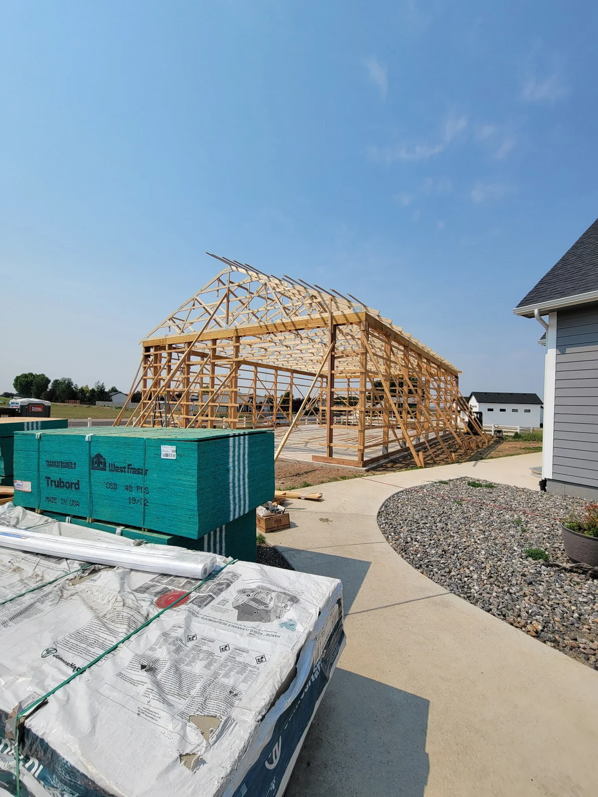 Exposed timber wall framing and roof trusses with temporary bracing at the Colorado Springs project